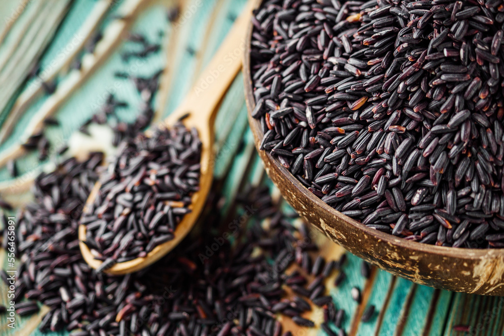 raw fresh black rice on wooden rustic background raw fresh black rice on wooden rustic background