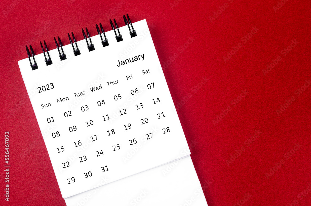The January 2023 Monthly desk calendar for 2023 year on red background. The January 2023 Monthly desk calendar for 2023 year on red background.
