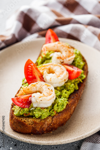 delicious Italian bruschetta with shrimps on a gray stone background