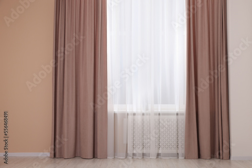 Window with beautiful curtains in room. Interior design