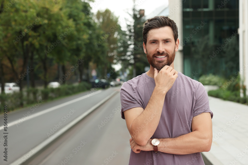 Portrait of handsome bearded man on street, space for text Portrait of handsome bearded man on street, space for text