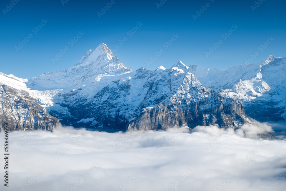 Obraz premium Mountains peaks and clouds in the valley. Natural landscape. Mountain range through the clouds. Landscape in the summertime. Large resolution photo.