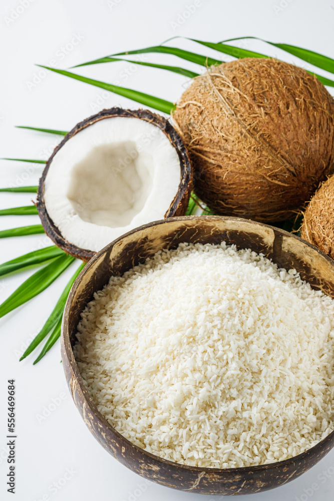 fresh natural coconut and shavings dried flakes on white acrylic background fresh natural coconut and shavings dried flakes on white acrylic background