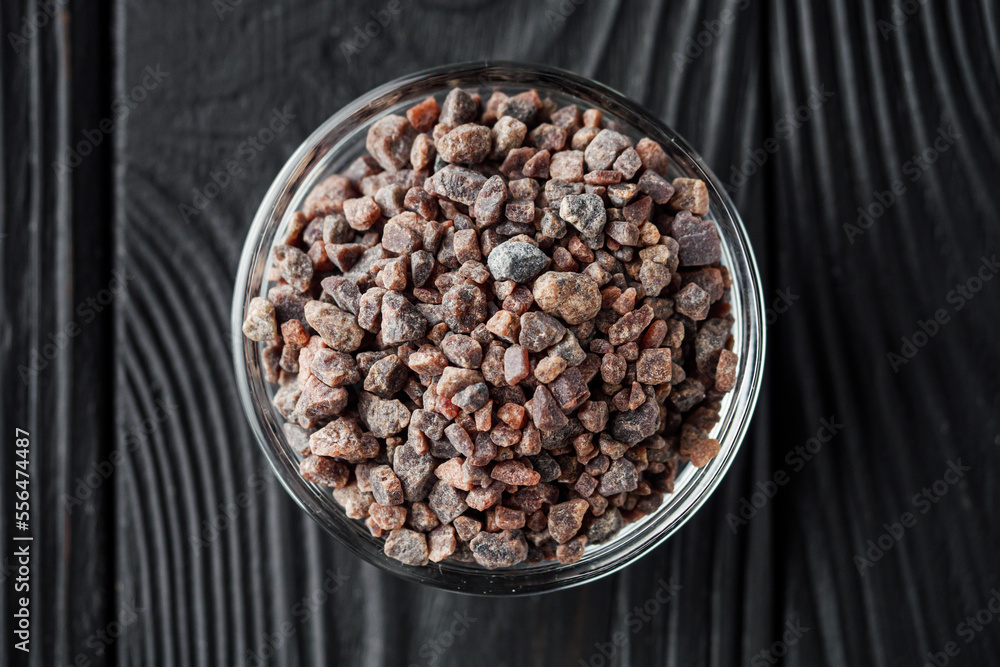 crystalline black Himalayan salt on a black wooden background crystalline black Himalayan salt on a black wooden background