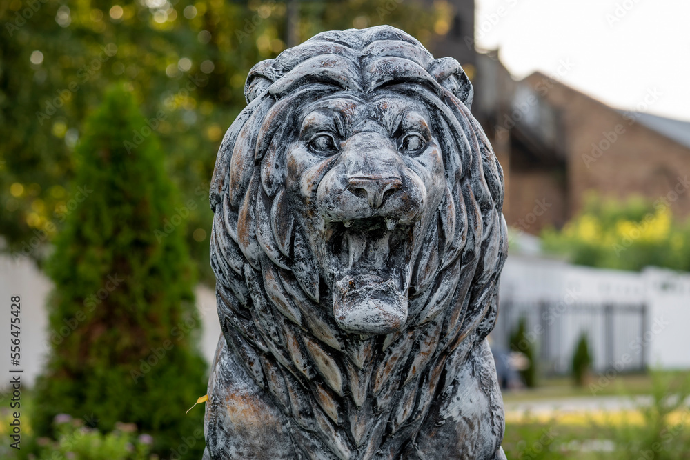 Sculpture of a lion in a park in Russia in the summer.