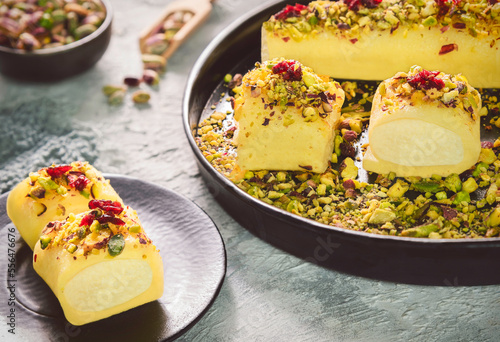 Middle Eastern traditional sweet cheese rolls " Halawet El Jebin". A delectable Arabic dessert made from sweet cheese dough that gets stuffed with clotted cream and crowned with crushed pistachio.