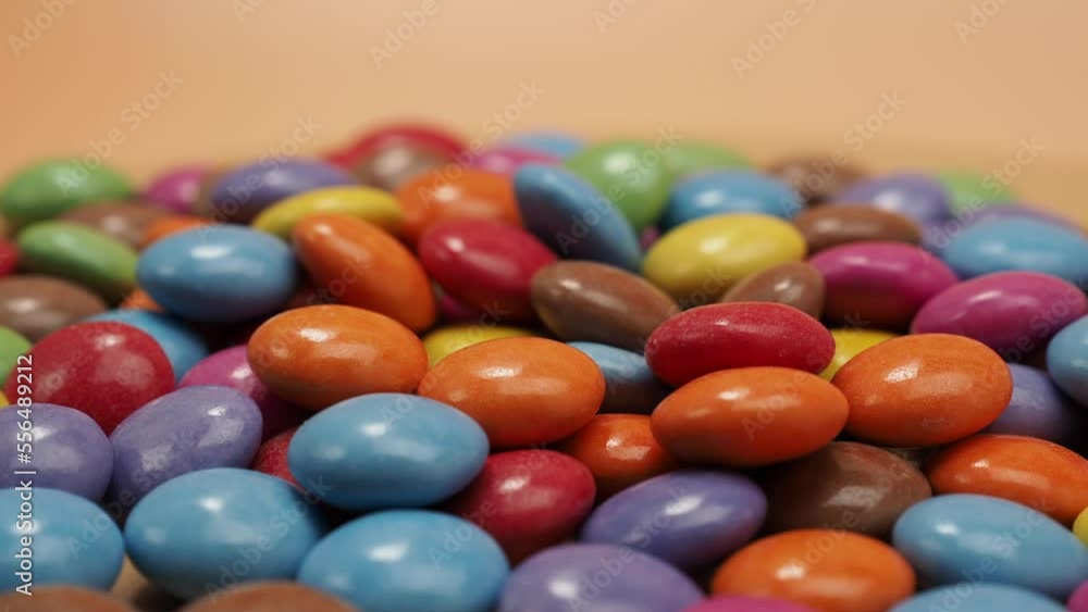 Small multi-colored round candies. Rotating Candies covered with sugar icing. Colored sweetness. Small multi-colored round candies. Rotating Candies covered with sugar icing. Colored sweetness.