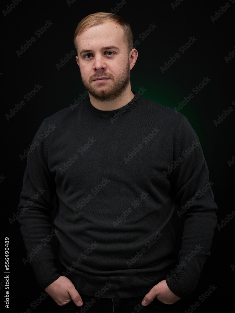 vertical portrait blond man on a dark background, in a jacket vertical portrait blond man on a dark background, in a jacket