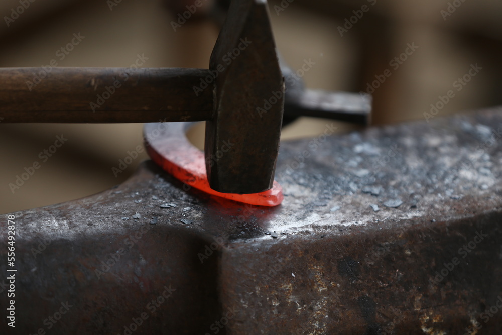 Blacksmith working at smithy workshop Blacksmith working at smithy workshop