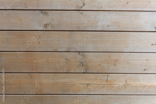 A hardwood aged wall. Wooden planks with texture of a natural tree. Beige background.