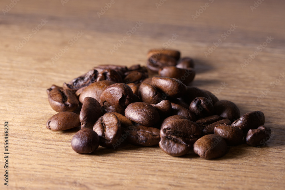 Coffee beans on wooden background. Macro shot. Coffee beans on wooden background. Macro shot.