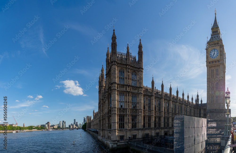Panoramic View of the London House of Parliament and Big Ben clock tower with clear blue skies from the Westminster Bridge