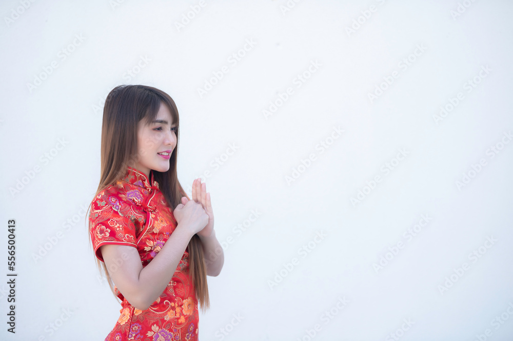 Portrait beautiful asian woman in Cheongsam dress on white background,Thailand people,Happy Chinese new year concept,Happy asian lady in chinese traditional dress Portrait beautiful asian woman in Cheongsam dress on white background,Thailand people,Happy Chinese new year concept,Happy asian lady in chinese traditional dress