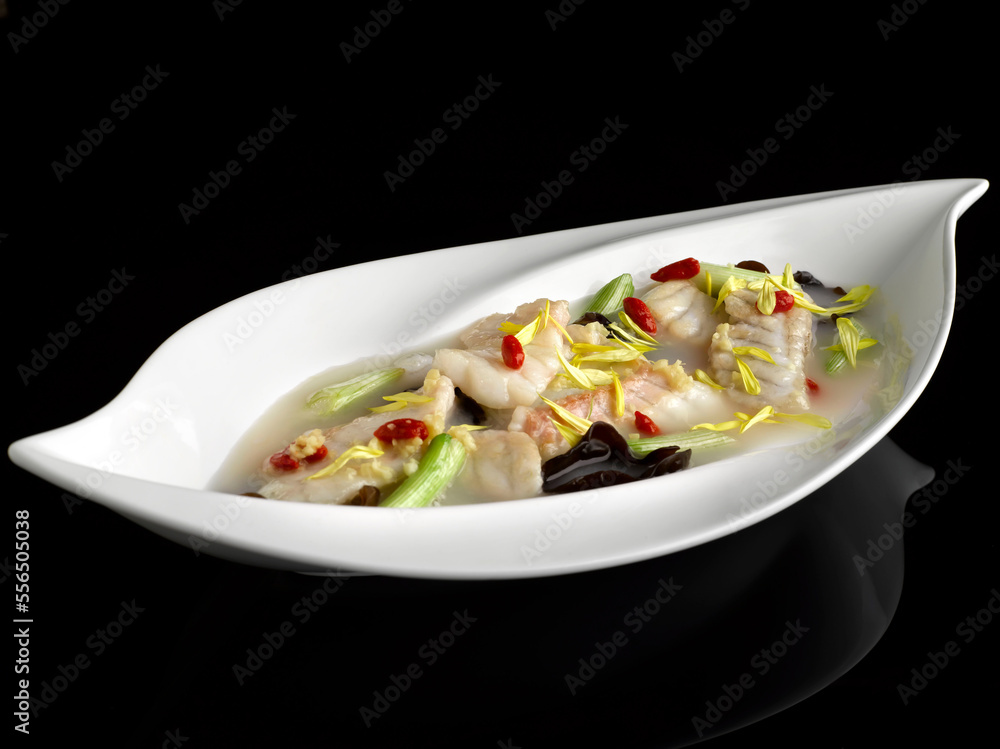 Poached Garoupa Fillet with Chrysanthemum and Ginger in Superior Rice Wine Broth served dish isolated on background top view food