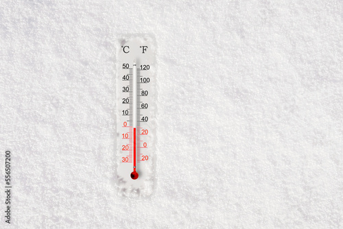 White celsius and fahrenheit scale thermometer in snow. Ambient temperature minus 1 degrees celsius