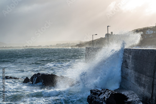 Waves crashing against the pier at Portnoo harbour after Storm Franklin - County Donegal, Republic of Ireland