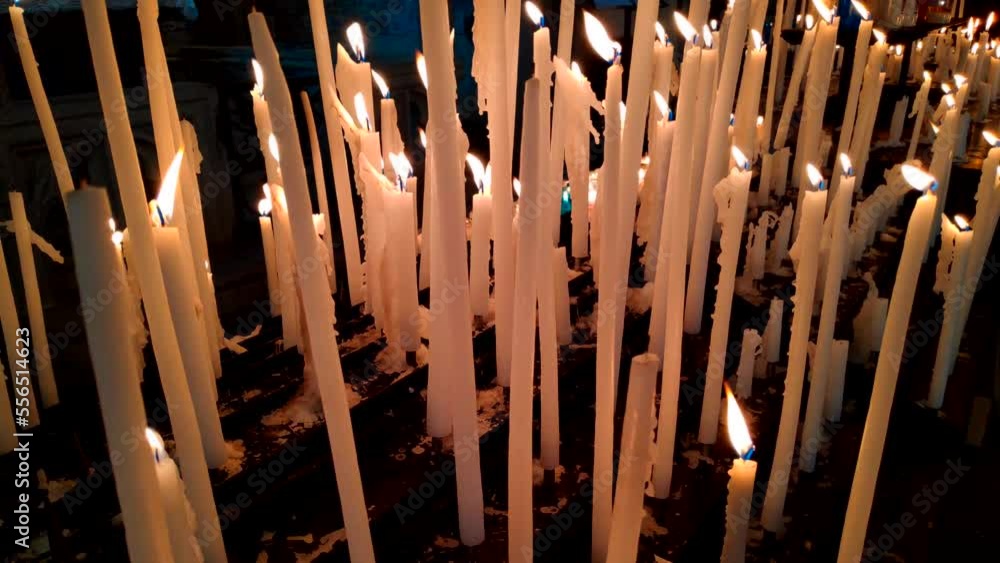Close up view of rows of lit candles in a church. Close up view of rows of lit candles in a church.