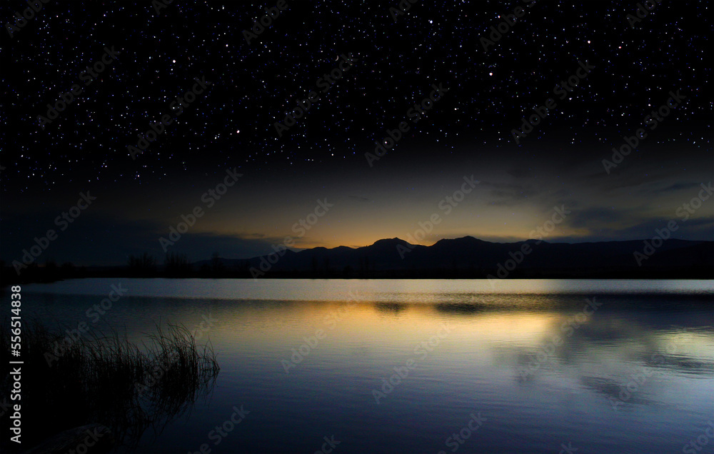 Last light of dusk over a lake surrenders to a starry sky Last light of dusk over a lake surrenders to a starry sky