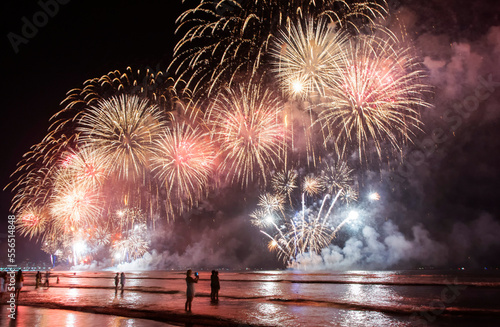 New Year on the beach. Celebrating with exploding colorful fireworks. 