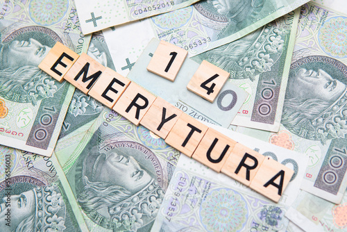 inscription 14 Emerytura which means 14 pension next to polish money. Concept showing program of social policy in Poland