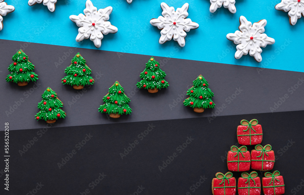 Christmas gingerbread covered with icing on a colored background, flat lay.