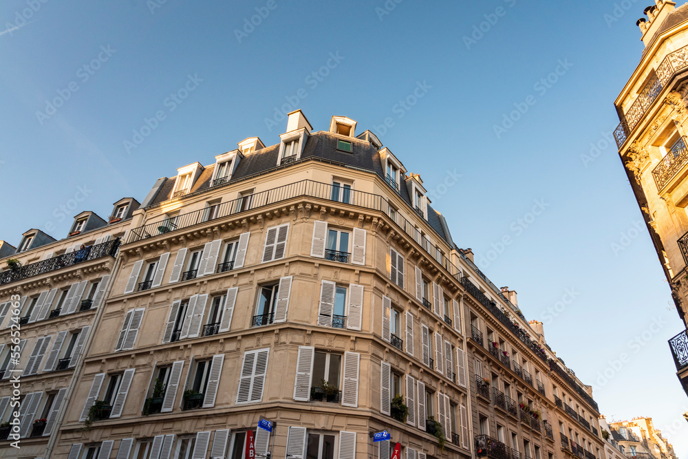 Traditional old building in the 2nd Arr. in Paris with blue sky, France