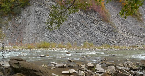 Prut river and mountain folds in Yaremche, Ukraine, known as Yaremche folds - biggest outcrop of Stryi formation in Europe. Here rocks of this formation are folded and faulted, gothic or chevron types photo