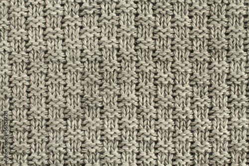 Light gray with black melange knitted wool fabric texture. Macro. Closeup.