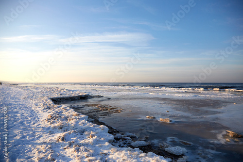 Fototapeta Naklejka Na Ścianę i Meble -  Winter view on the icy sea coast and beautiful calm sky, selective focus