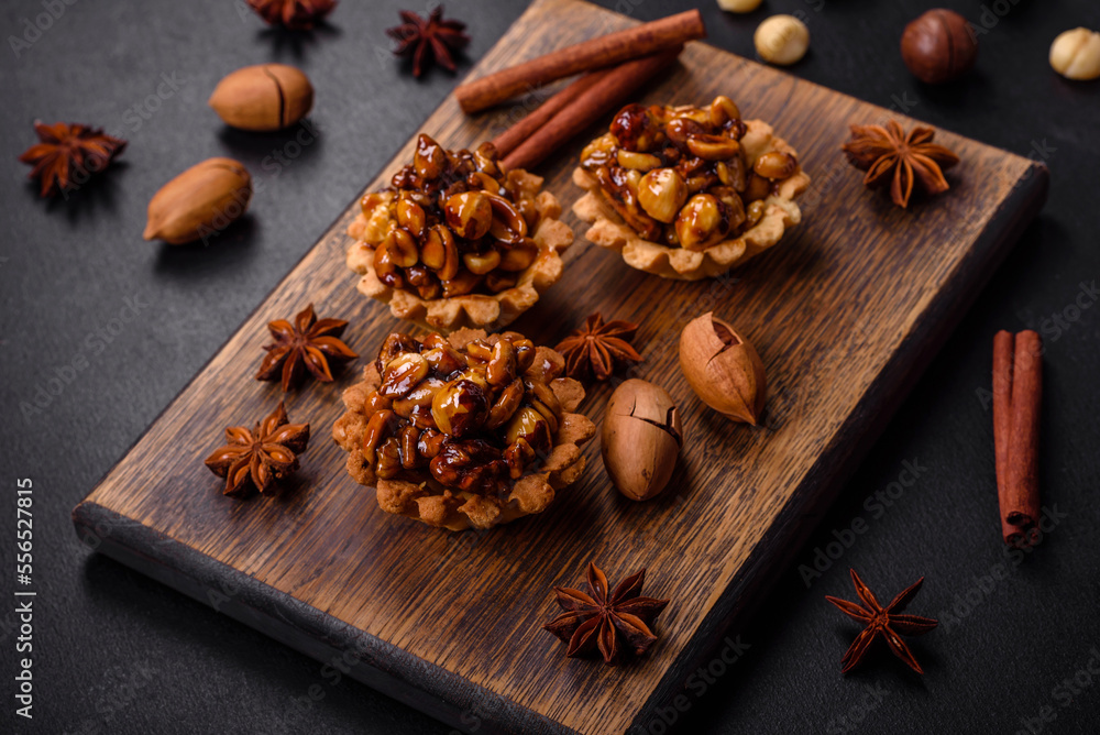 Sweet tasty tart with nuts and honey on a dark concrete background Sweet tasty tart with nuts and honey on a dark concrete background