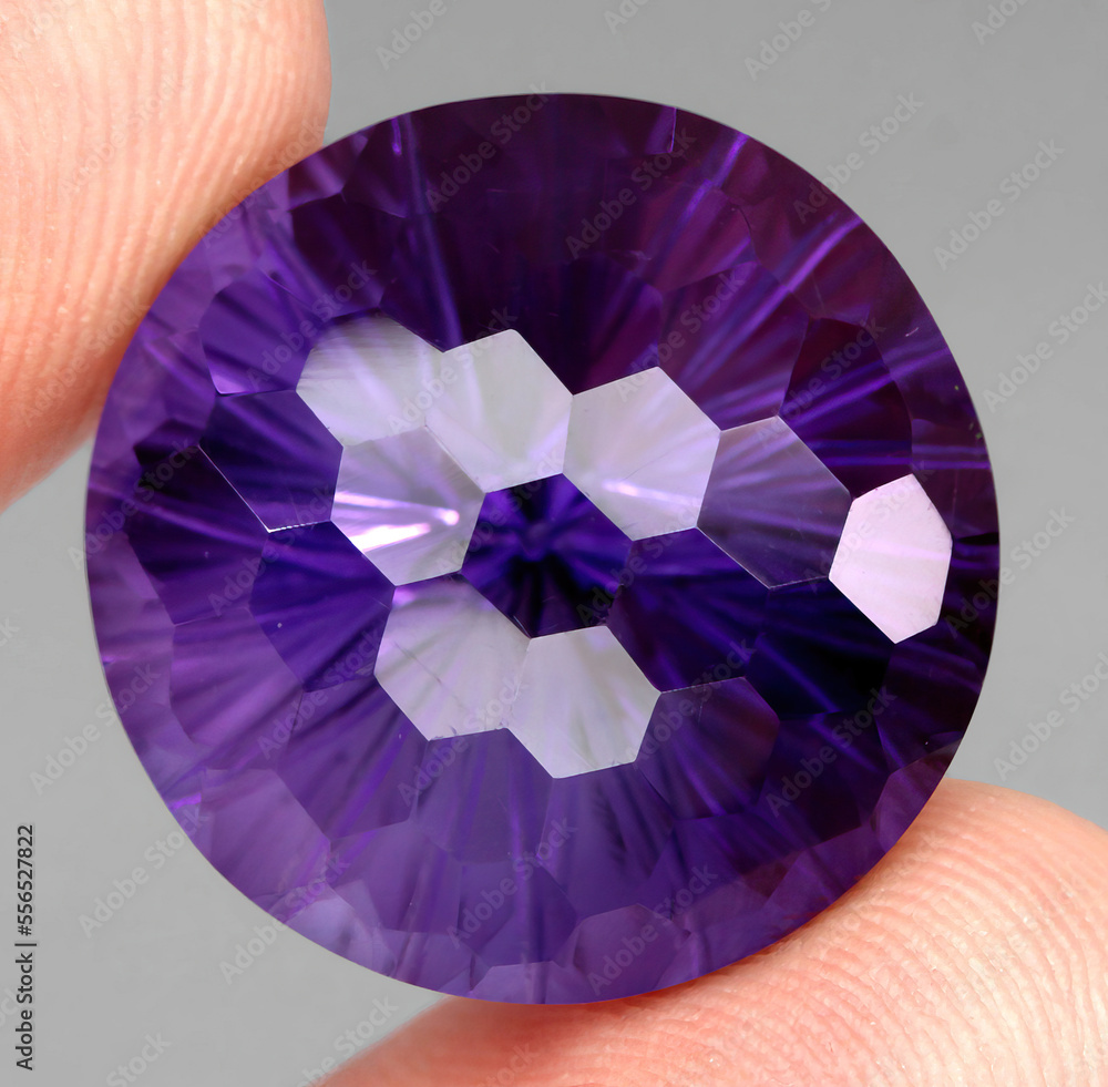 Natural stone purple amethyst on a gray background Natural stone purple amethyst on a gray background