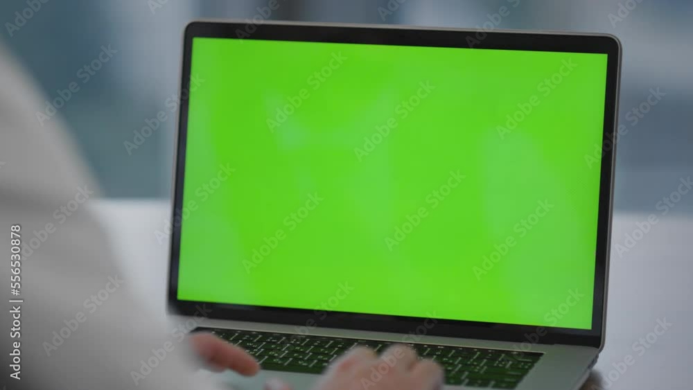 Woman typing mockup laptop on office desk closeup. Lady using chroma key monitor Woman typing mockup laptop on office desk closeup. Lady using chroma key monitor