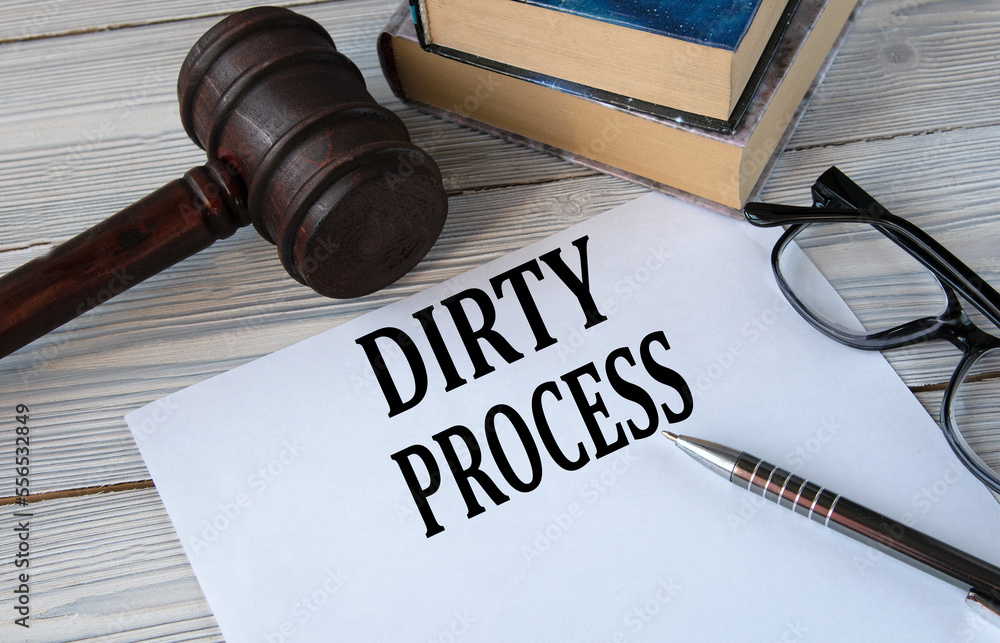 DIRTY PROCESS - words on white paper with the background of the judge's hammer, glasses and pen DIRTY PROCESS - words on white paper with the background of the judge's hammer, glasses and pen