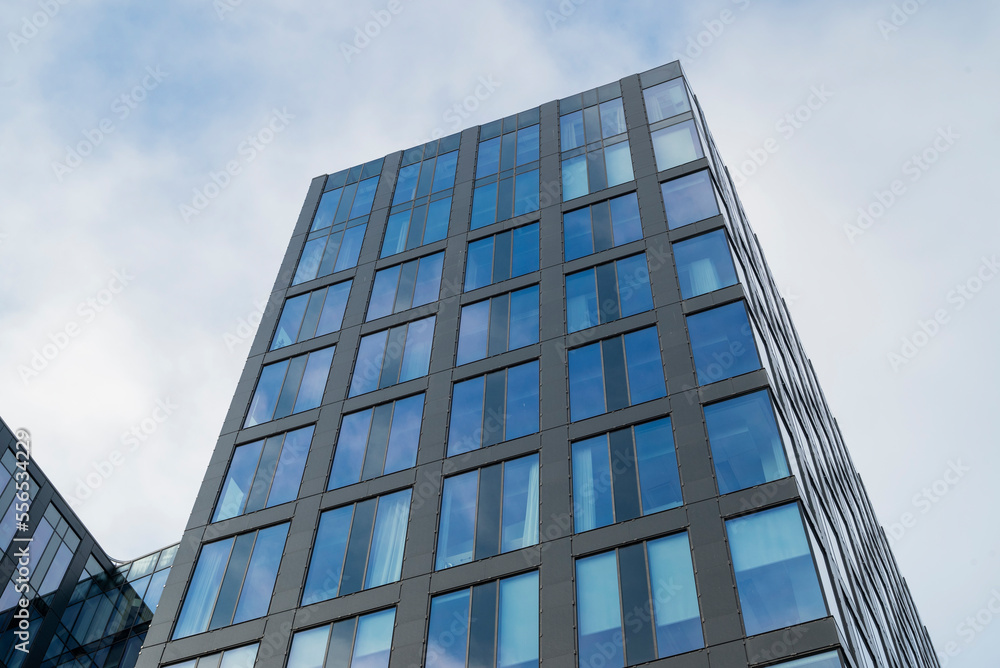 facade of modern architecture building with windows with sky reflection facade of modern architecture building with windows with sky reflection