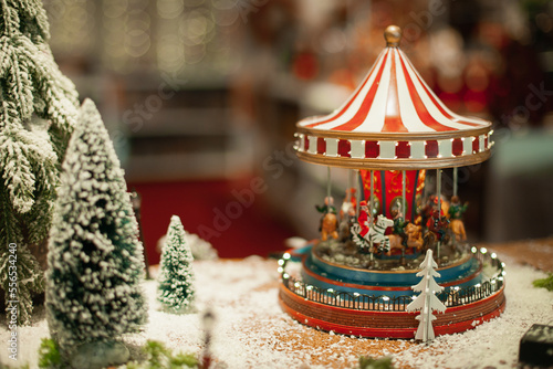 Vintage carousel home decoration for winter holiday season on sale at Christmas market. Festive xmas background wallpaper.
