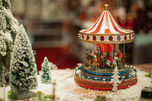 Vintage carousel home decoration for winter holiday season on sale at Christmas market. Festive xmas background wallpaper.