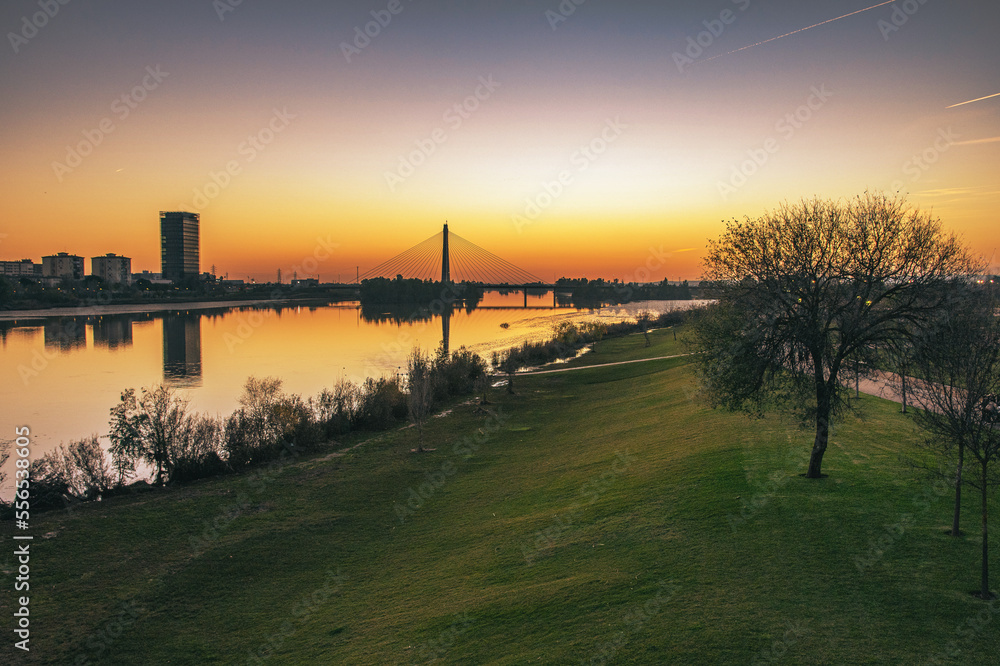 Sunset In The City. View Of A Bridge On The Horizon Next To The Guadiana River. Sunset In The City. View Of A Bridge On The Horizon Next To The Guadiana River.