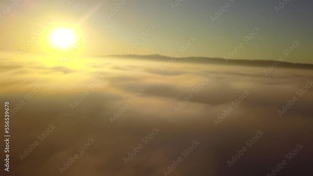Sunset over foggy valley. Flying above coulds with a beautiful sunset Sunset over foggy valley. Flying above coulds with a beautiful sunset