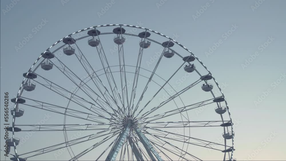 Vacation for famaly, amusement rides in a park. Ferris wheel silhouette at sunset clean sky. Vacation for famaly, amusement rides in a park. Ferris wheel silhouette at sunset clean sky.