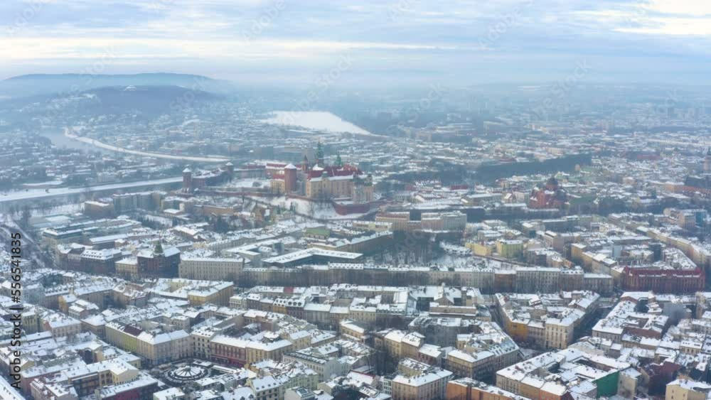 Aerial view of Krakow during winter. Castle and Cathedral in Cracow, Poland, with walking people, snow and promenade in winter. Aerial panning video. Beautiful Krakow, Poland Cityscape in Winter. Aerial view of Krakow during winter. Castle and Cathedral in Cracow, Poland, with walking people, snow and promenade in winter. Aerial panning video. Beautiful Krakow, Poland Cityscape in Winter.