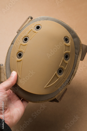 Protective knee pads for soldiers on a beige background