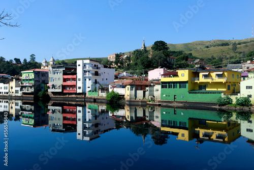 Colorful houses in Pirapora do Bom Jesus reflect in the calm waters of the Tiete River. Sao Paulo State, Brazil photo