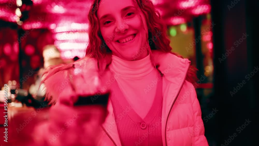 Beutiful woman in a jacket clinking her glass of cherry liqueur with me POV Beutiful woman in a jacket clinking her glass of cherry liqueur with me POV