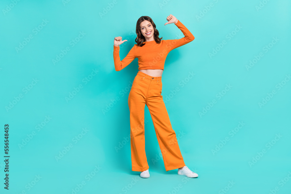 Full length photo of cheerful adorable lady arm pointing herself nice choice cool outfit isolated on cyan color background Full length photo of cheerful adorable lady arm pointing herself nice choice cool outfit isolated on cyan color background