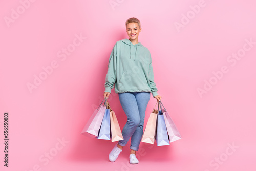 Full length photo of lovely pretty glad lady wear trendy clothes satisfied nice shopping mall center isolated on pink color background