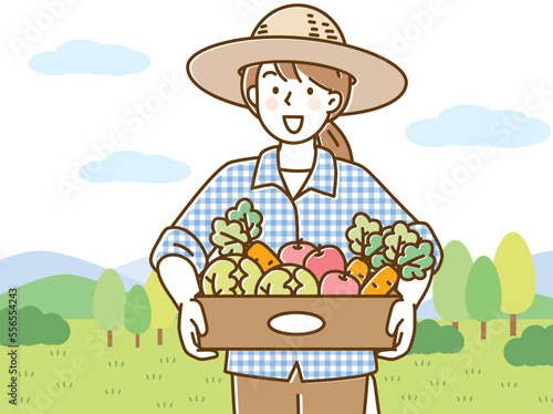 麦わら帽をかぶって野菜の箱を持つ若い女性
