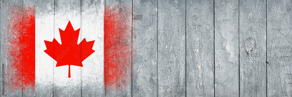 Flag of Canada. Flag is painted on a gray wooden plank surface. Wooden background. Plywood surface. Copy space. Textured background Flag of Canada. Flag is painted on a gray wooden plank surface. Wooden background. Plywood surface. Copy space. Textured background