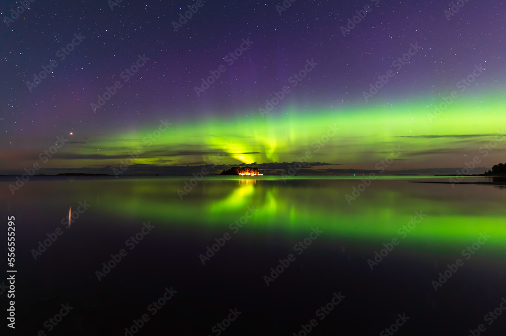 Northern lights, reflections in the water. Storsand Jakobstad/Pietarsaari. Finland