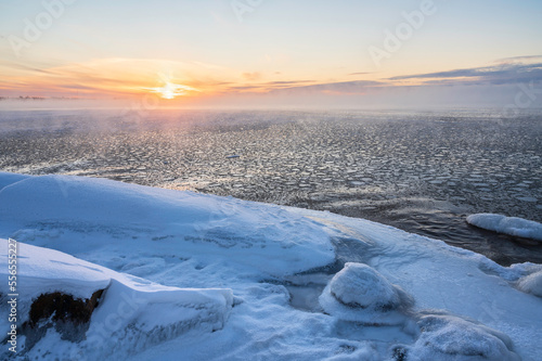 View of the frozen sea and setting sun. Pörkenäs, Finland.