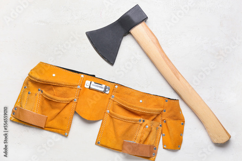 Ax and tools belt on white ...